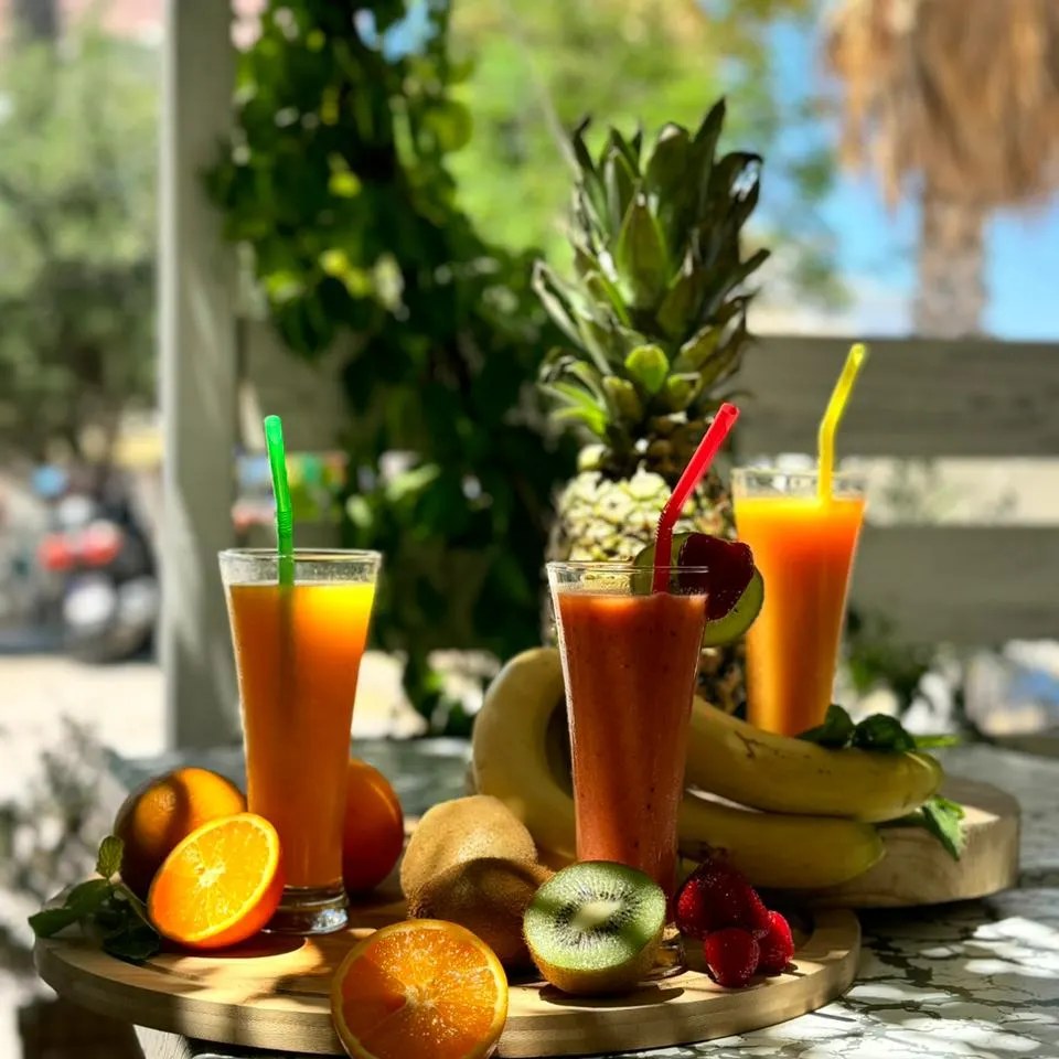 Fresh fruit juices on a wooden tray